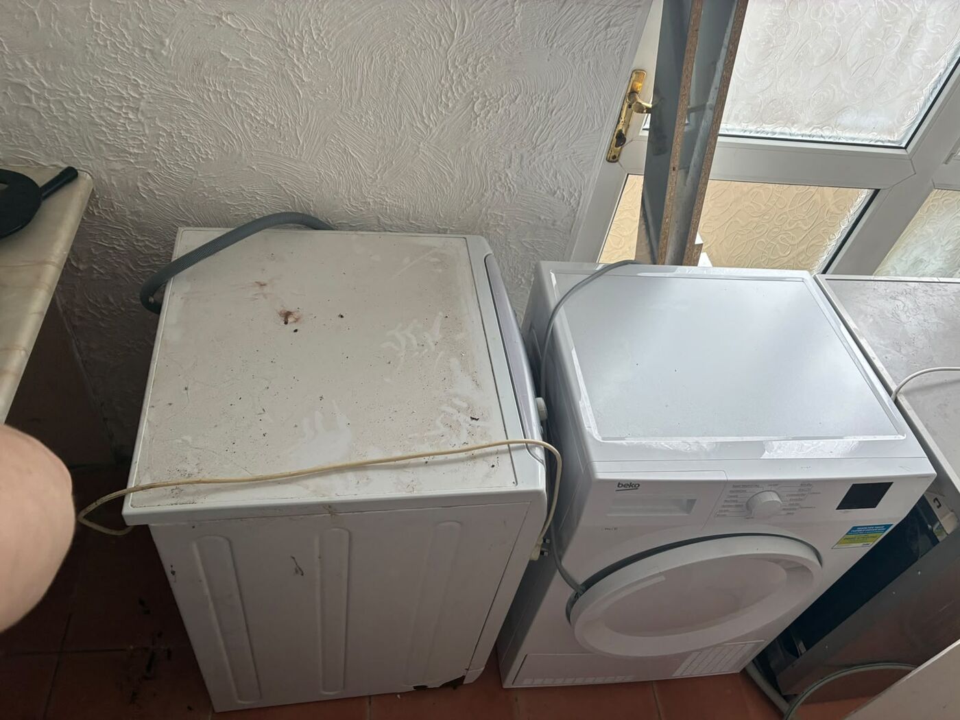 Washing machine and dryer pulled forward to access the supply and waste connections