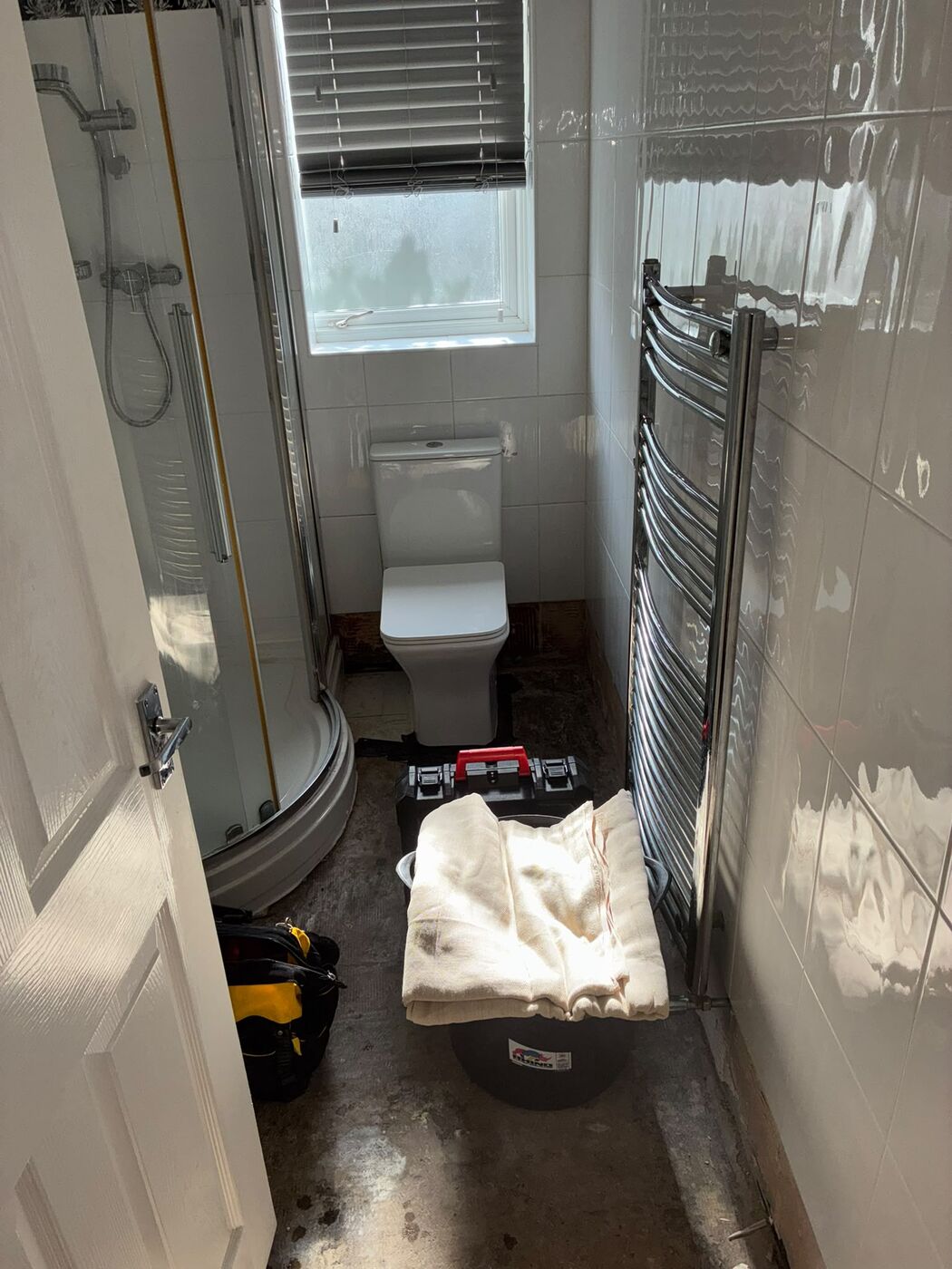 Bathroom part way through strip-out with toilet and towel radiator still in place