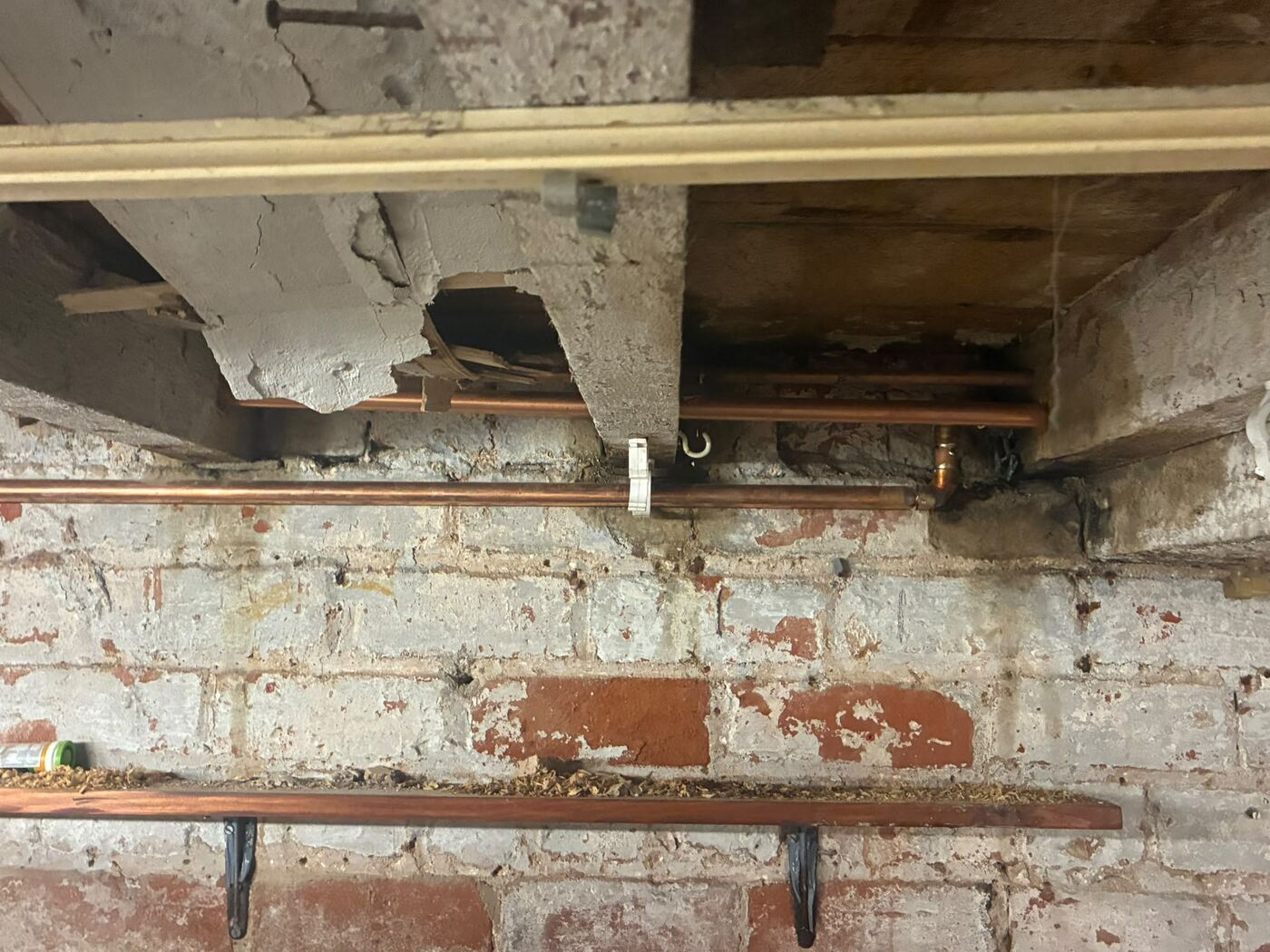 Copper flow and return pipe work re-run through joists in a cellar